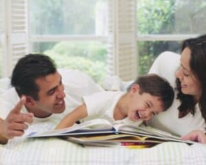 Parents Reading to Laughing Boy